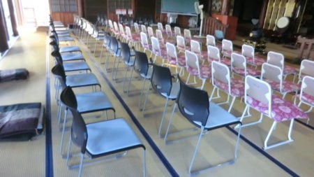 お寺の本堂大部分を椅子が占める。